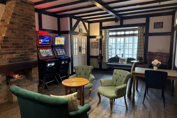 Pub lounge seating beside the open fire at The Horse and Jockey Bentley