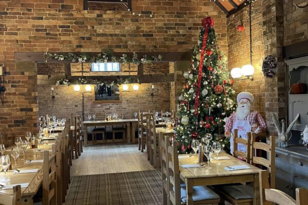 Barn restaurant dressed for Christmas dining at The Horse and Jockey Bentley