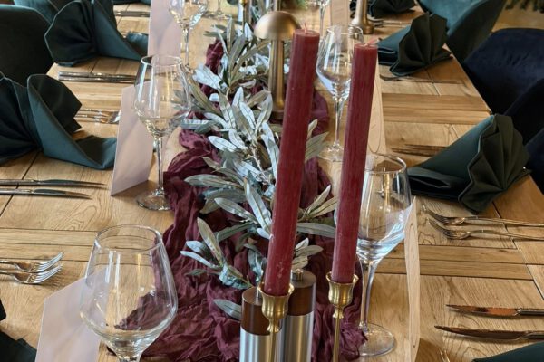 Celebration table with candles and flowers in The Horse and Jockey Bentley barn restaurant