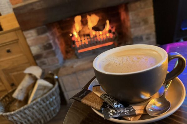 Hot drink beside the open fire at The Horse and Jockey Bentley
