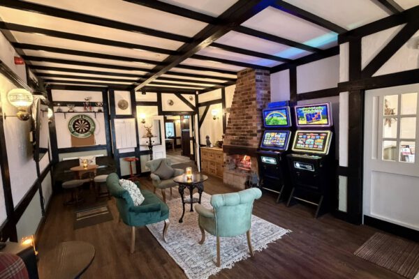 Games lounge with dartboard and seating at The Horse and Jockey Bentley