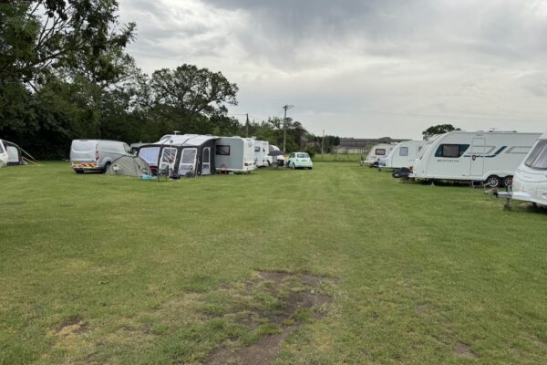 Touring caravans on grass pitches at The Horse and Jockey Bentley campsite